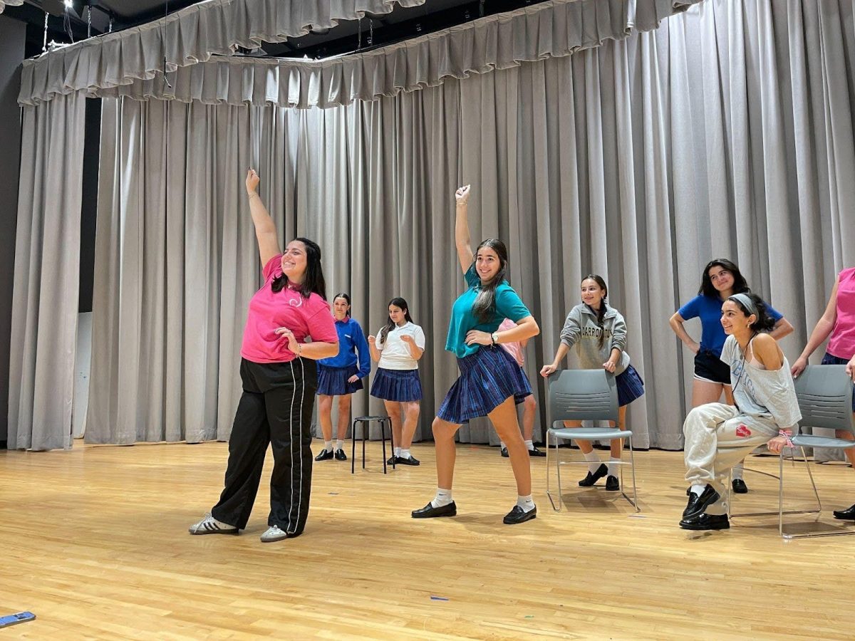 Choreographer Mrs. Sasloglou instructs various actors on the “bend-and-snap” at practice for this year’s production of “Legally Blonde Jr.”