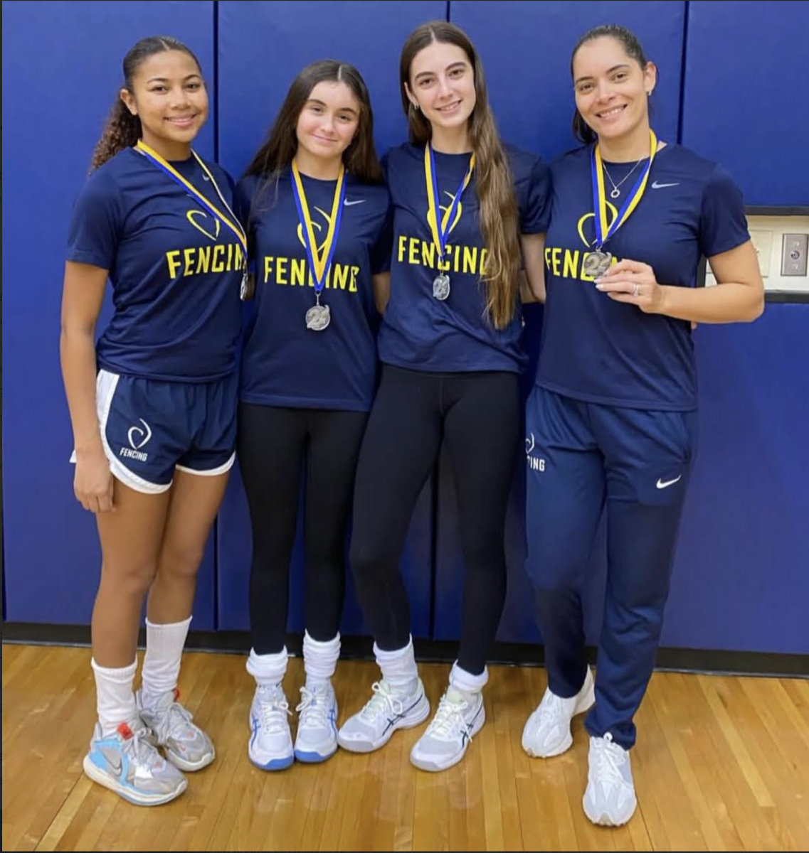(left to right): Layla Smith, Anna-Sophia Pinzon, Ferreira, and Carrollton Fencing Club coach, Susana Fornaris after winning second place at the South Florida School Fencing League Fall Tournament at Belen in Oct. 2025.