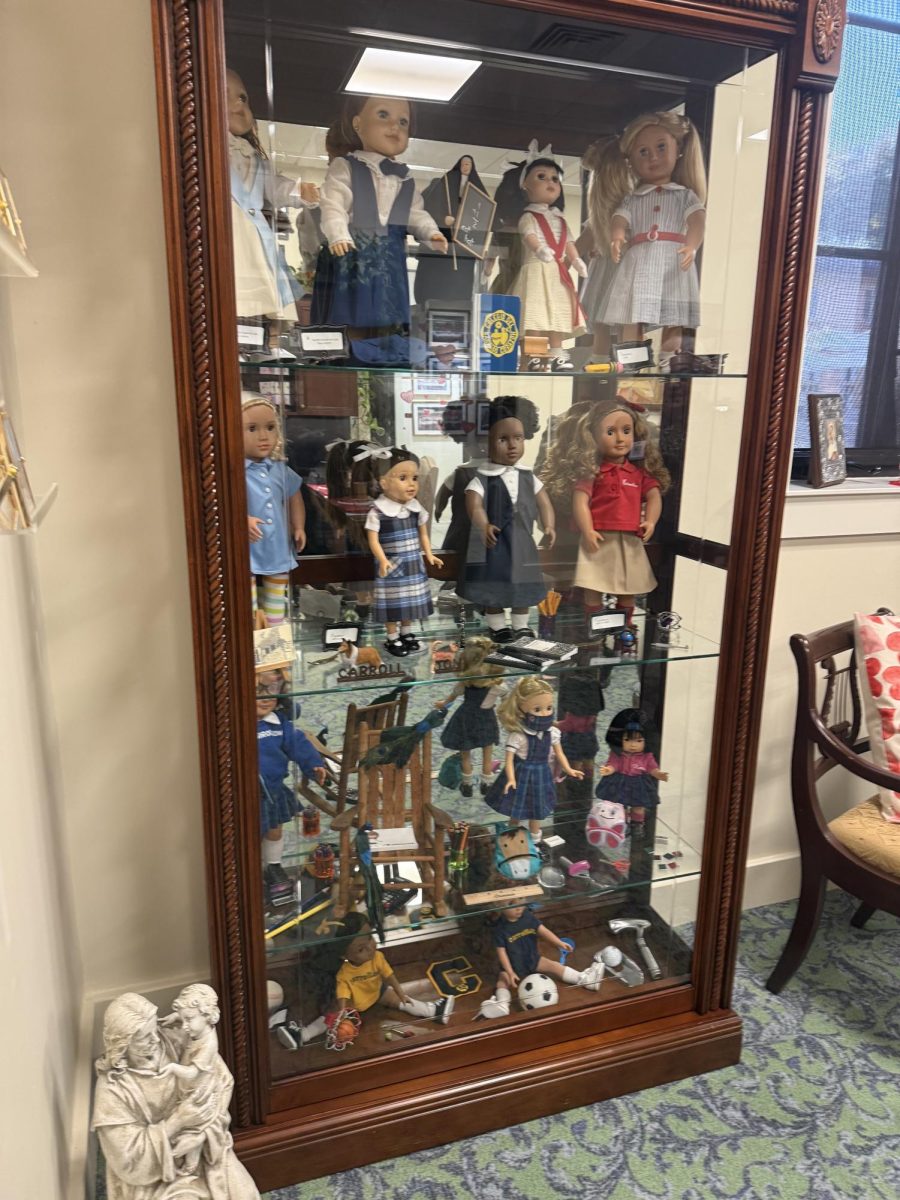 Mrs. Fernandez keeps old Carrollton uniforms displayed in her office. 
